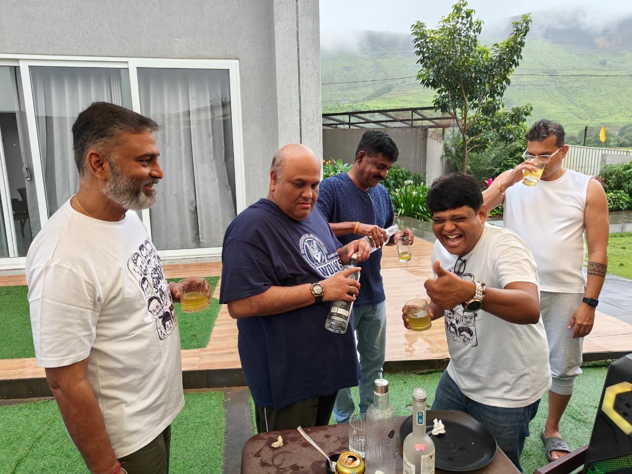 Drinks on the deck with the green hills behind