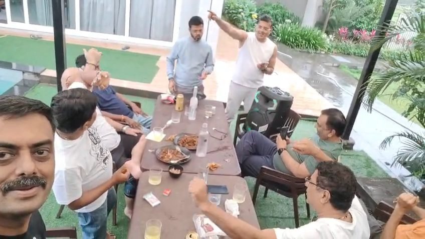 Panning across the long table as everyone settles in