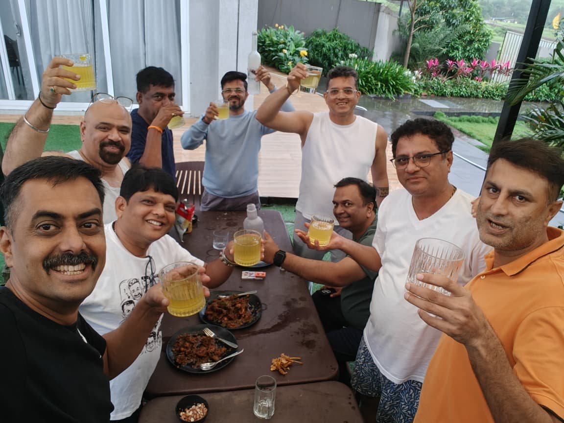 A selfie down the length of the table, everyone raising a glass